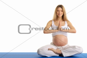 pregnant woman with closed eyes practicing yoga