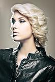 Beautiful young blond fashion model with leather jacket 