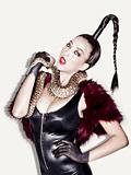 Edgy Fashion Model with fur and snake shot in studio