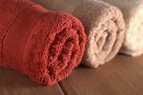 Rolled Up Towels on Wood