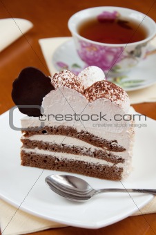 Tea and a slice of cake with cream