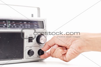 Hand Turning Up the Volume on Vintage AM FM Radio