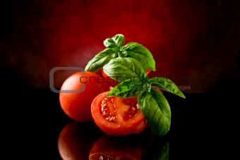Sliced Tomatoes with basil on glass table