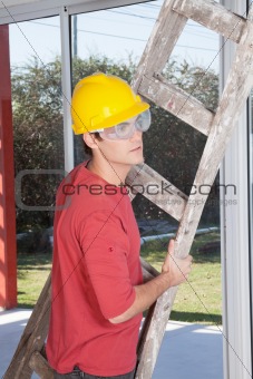 Male construction worker with a ladder