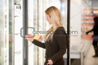 Woman Buying Juice from Cooler