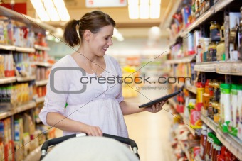 Smiling woman looking at digital tablet in shopping centre