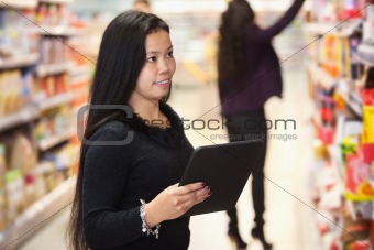 Woman using digital tablet in shopping centre