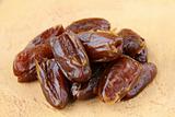 Delicious fresh organic dates on wooden table