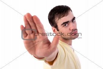 young man with his hand raised in signal to stop, isolated on white background, Studio shot
