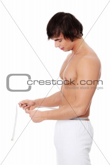 Young man's measuring himself.