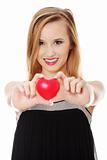 Beautiful young casual woman holding red heart