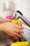Woman hands washing apple