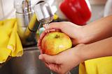 Woman hands washing apple