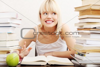 oung student woman with lots of books studying for exams.