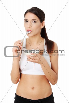 Young beautiful woman eating yogurt