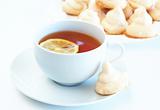 Cup of tea with lemon and meringue cookies