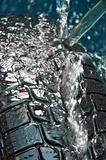 Washing tire on blue blurry background