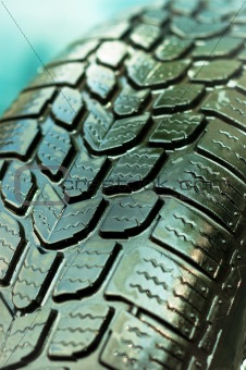 Wet car tire texture in green and blue colors