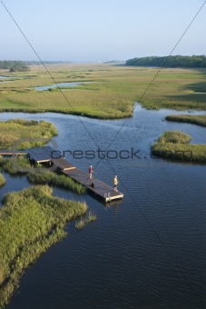Boys on dock in marsh.