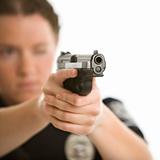 Policewoman aiming gun.