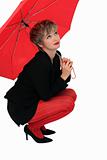 Businesswoman with a red umbrella