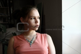 Unhappy teen by the window