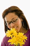Woman smelling bouquet.