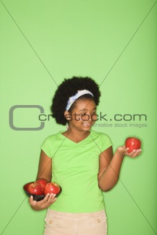 Girl holding fruit.