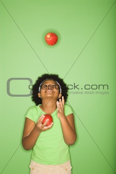 Girl juggling apples.