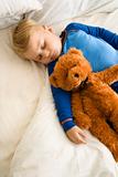 Child sleeping with teddy.