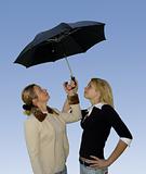 2 women under the umbrella