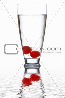 Glass of fresh water with cherries