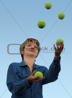 Woman juggling with tennis balls