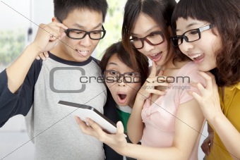 young group using tablet pc and surprised