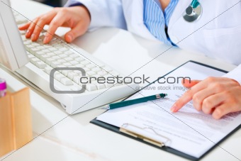Medical doctor woman working at office table. Close-up.
