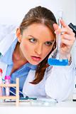 Thoughtful doctor woman in laboratory analyzing results of medical test
