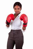 Young black woman wearing boxing gloves