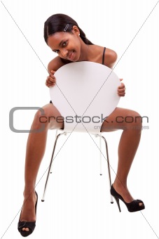 Sexy young black woman posing in chair