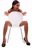 Sexy young black woman posing in chair