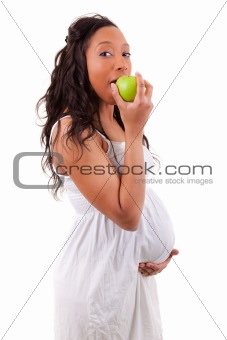 Pregnant african american woman eating an apple