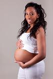 Pregnant african woman touching her belly