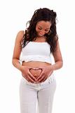 African woman holding her hands in a heart shape on her pregnant