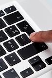 black finger typing on computer keyboard 