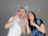 Pretty couple in love blowing bubbles and having fun