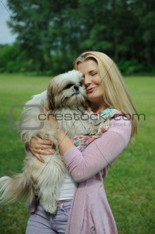 Pretty casual woman with cute little shih tzu dog outdoors