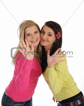 Two pretty girl friends having fun and laughing. isolated