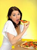 Pretty young casual brunette girl eating tasty pizza 