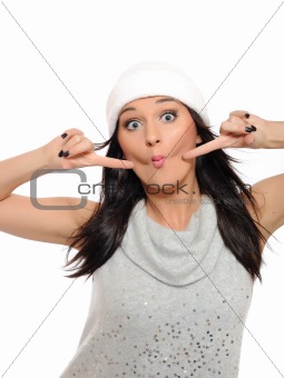 Expressions. Beautiful winter girl in a hat having fun. isolated