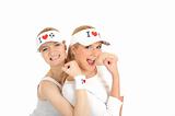 Two pretty football fan girls in funny hats. isolated on white