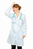  Surprised medical doctor woman striking her forehead
